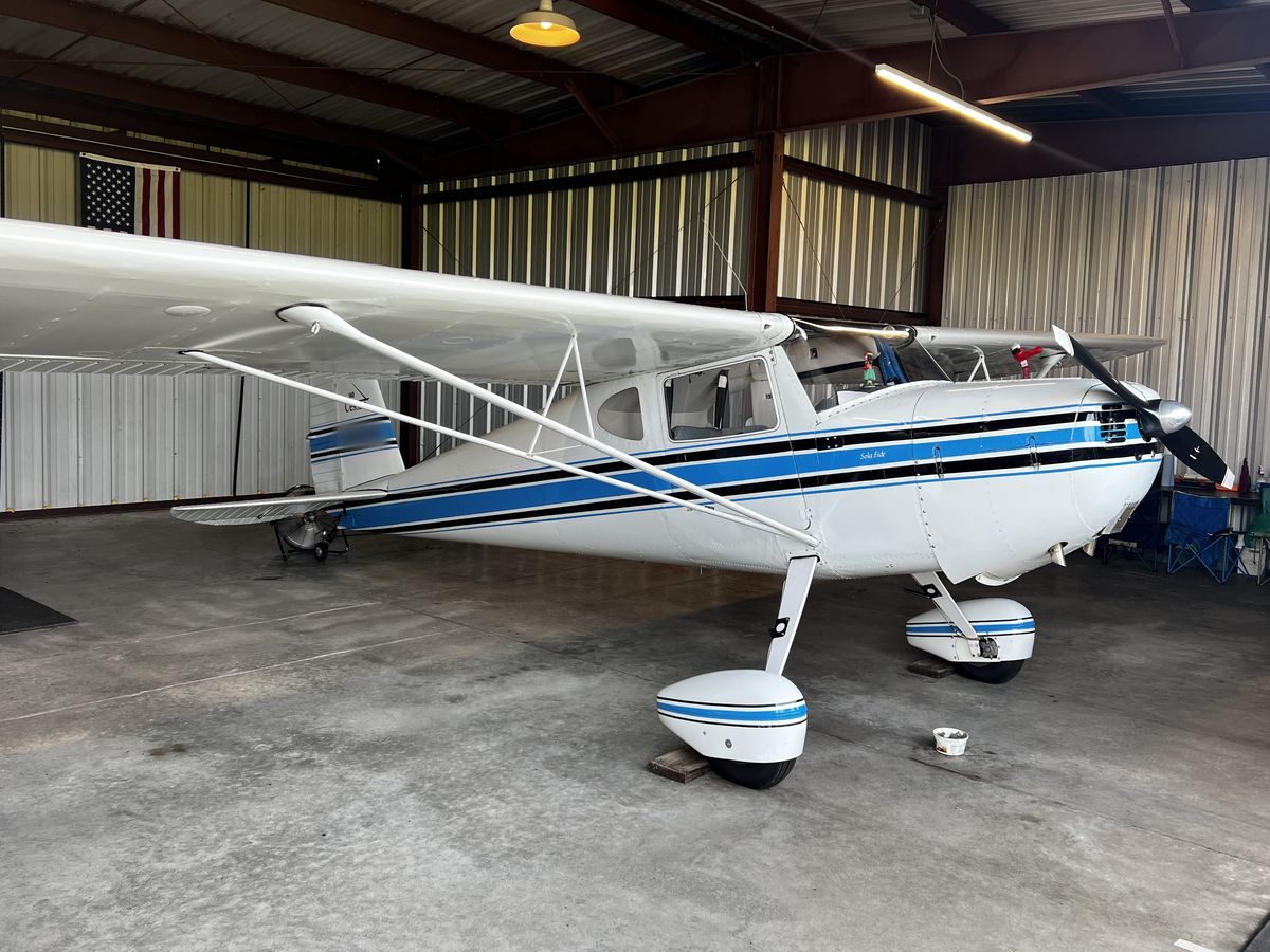 A restored Cessna 140 back together in the hangar